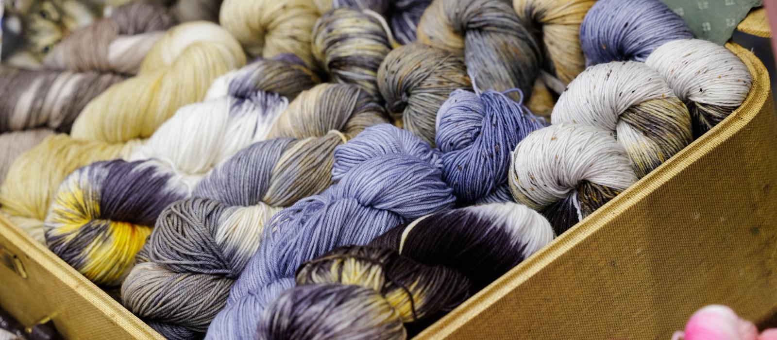 Shelves of yarn in a range of colours at a craft supply store