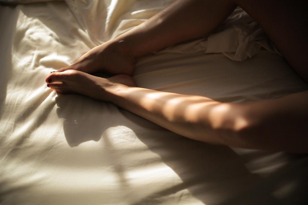 Kjønnssykdom: bena til en kvinne i sengen