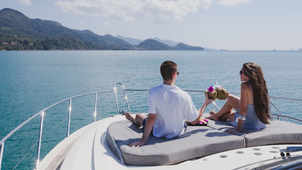 couple enjoying honeymoon onboard of luxury boat, luxurious yacht