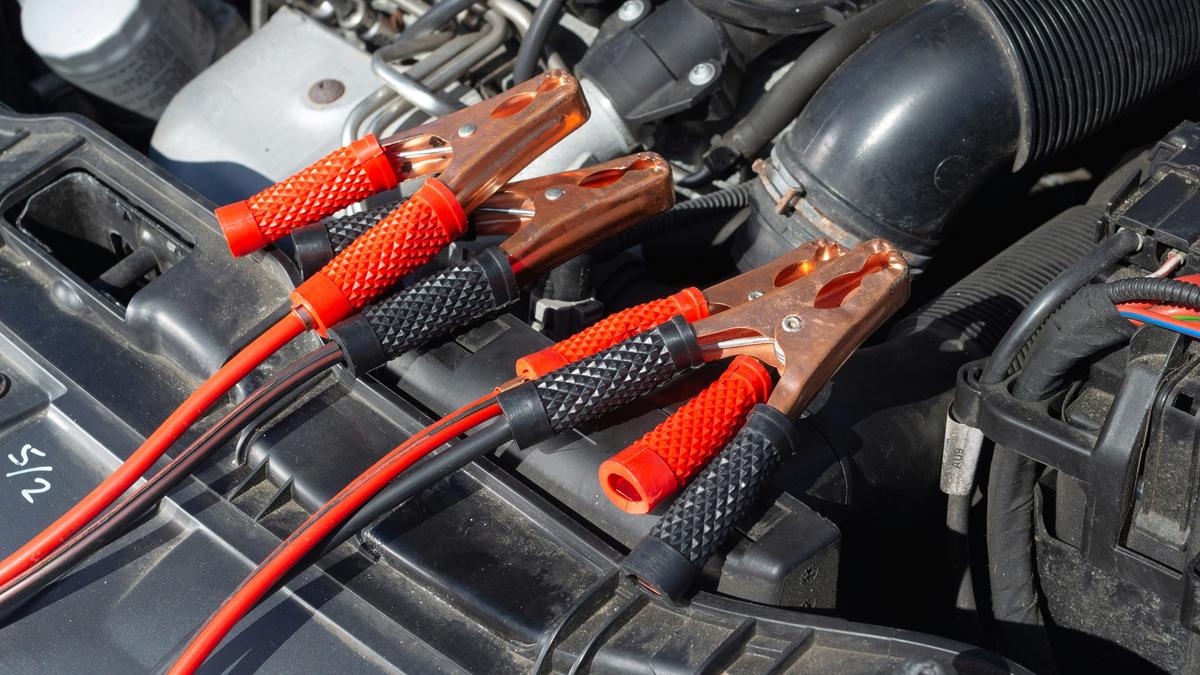 Jump leads resting in an open engine bay