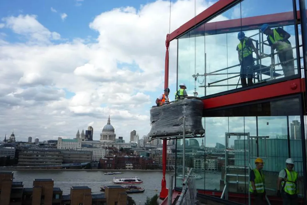 Construction workers in hi-vis working on scaffolded glass winter gardens overlooking the riven Thames and St Paul's Cathedral