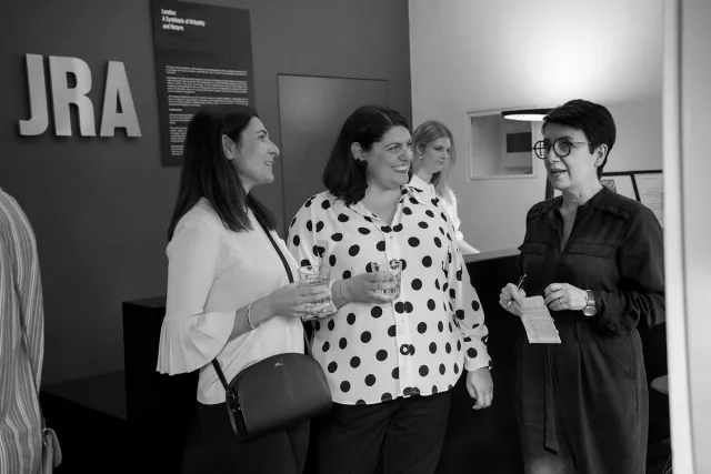 people standing talking at exhibition