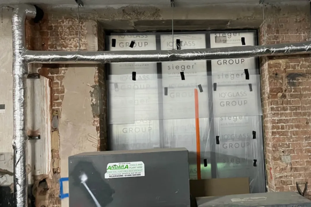 A building site with pipe ducting across windows