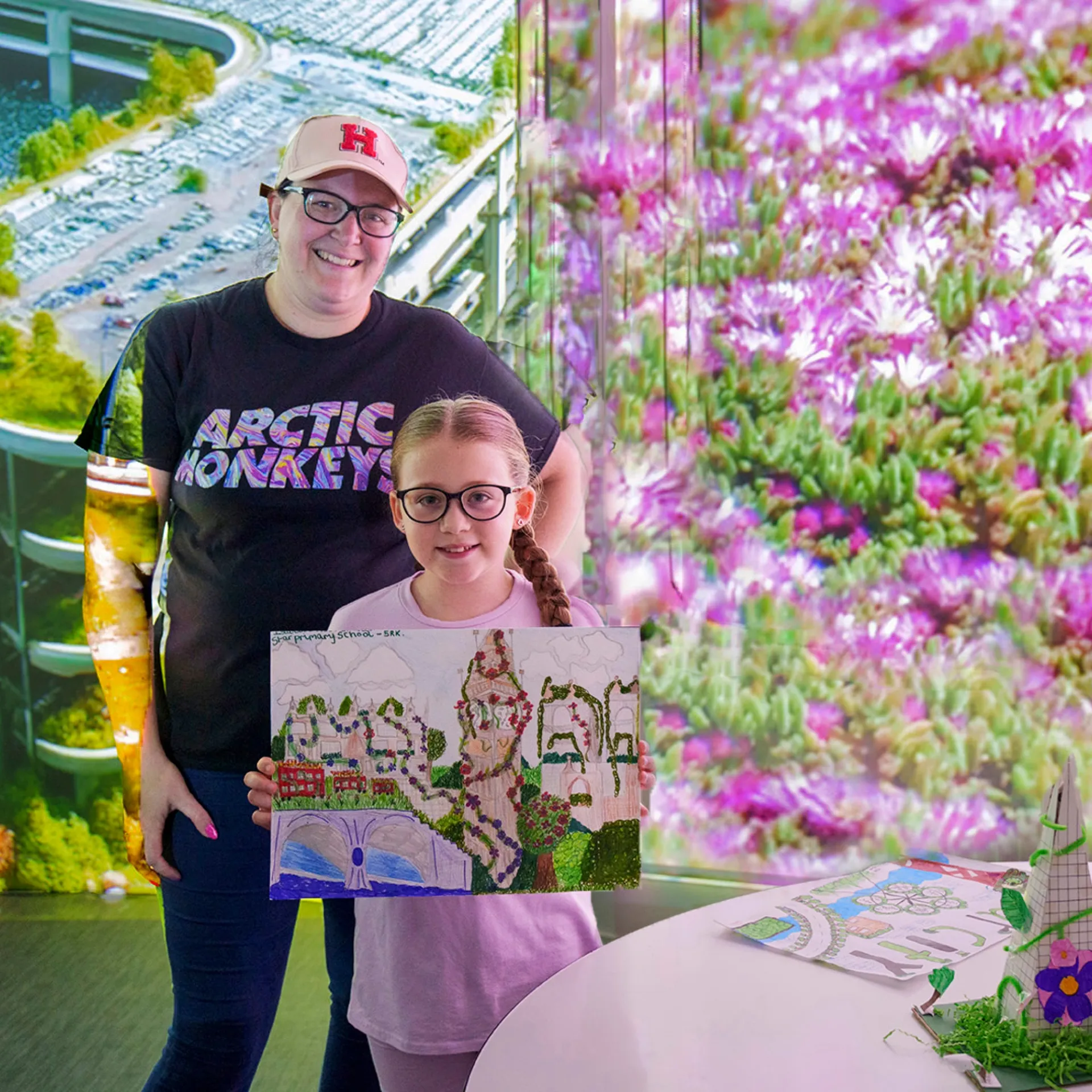 child with artwork and teacher
