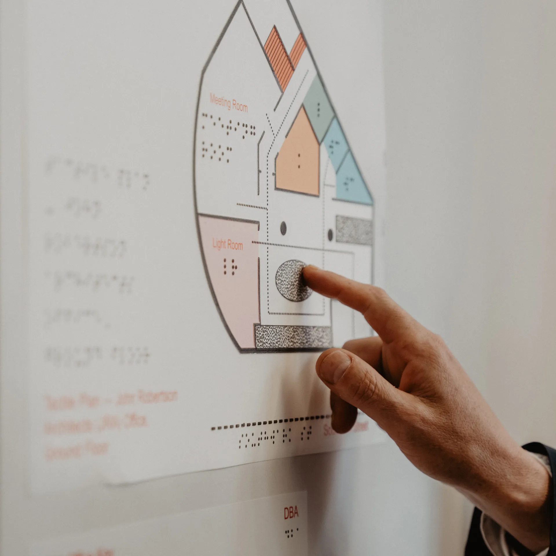 Hand touching tactile floorplan