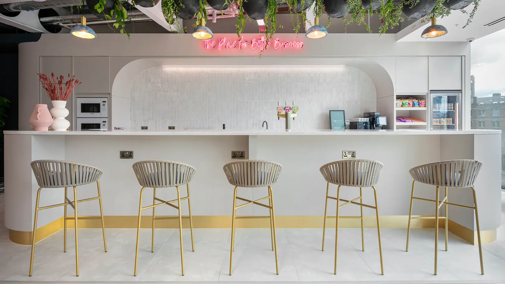 A row of high stools at an office kitchenette counter