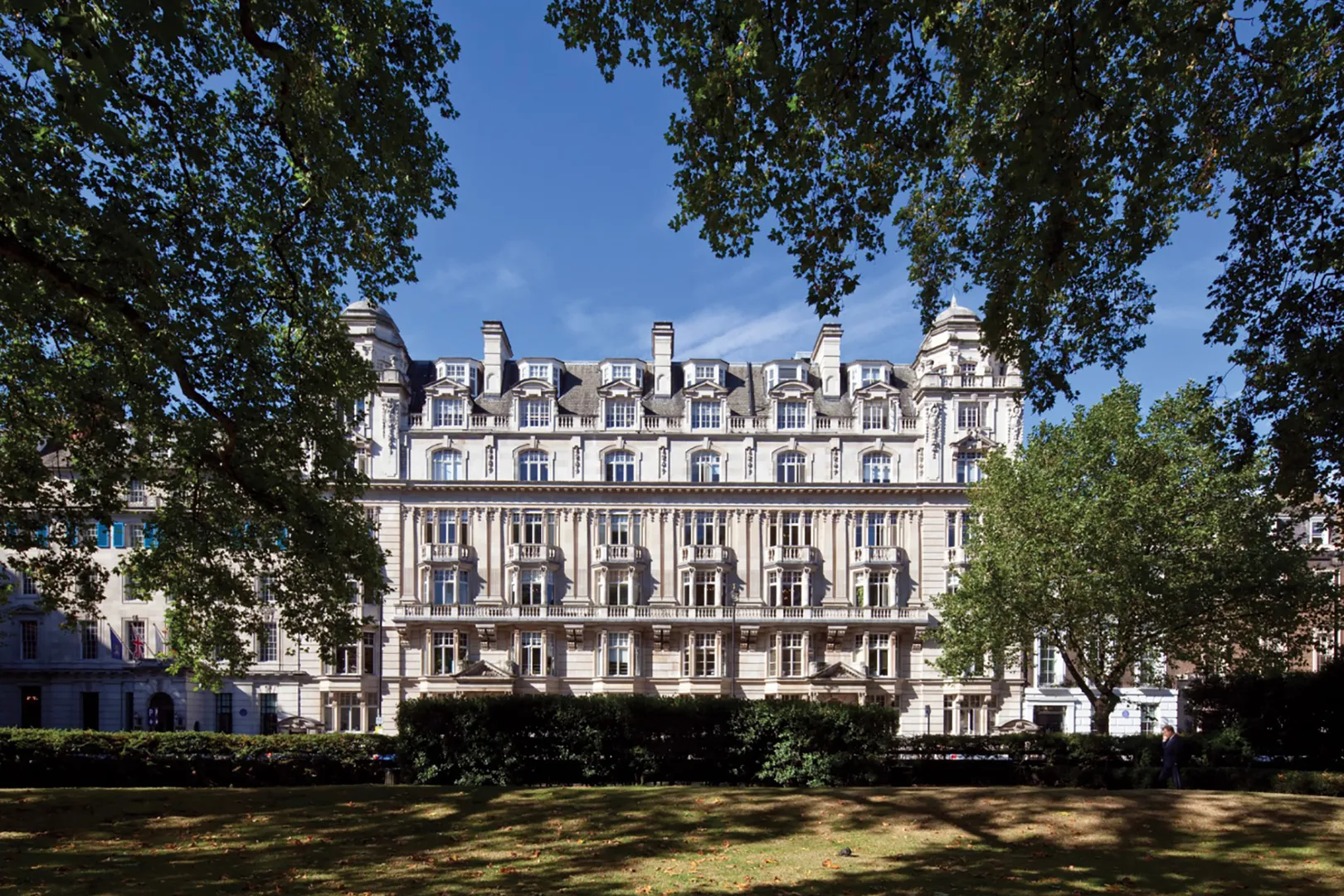 Large classical building viewed from park