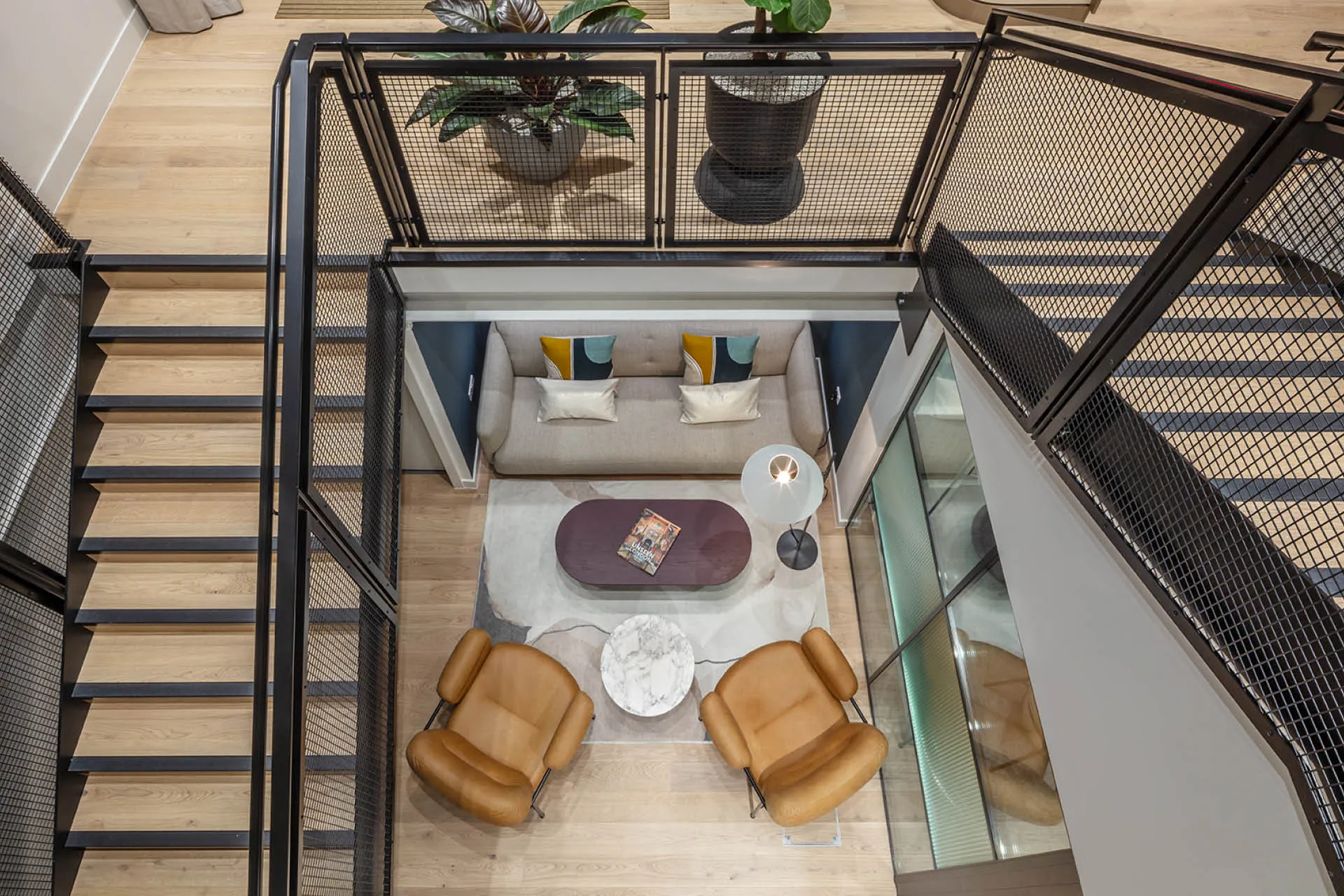 Aerial view of a sofa and armchairs from a staircase