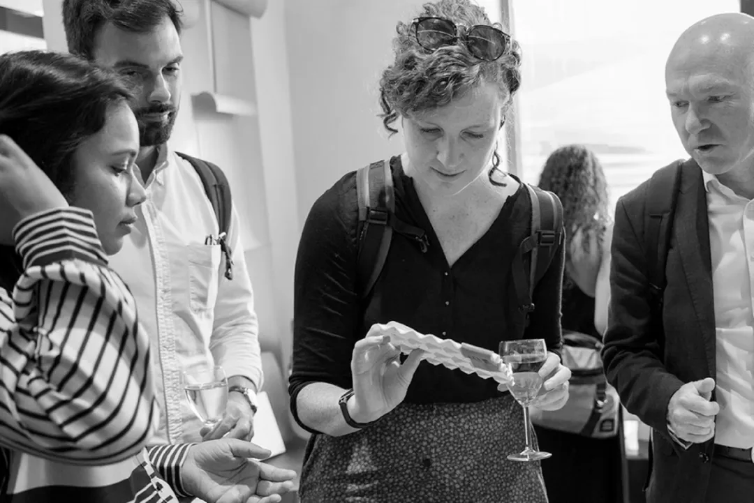 People talking at reception with wine glasses