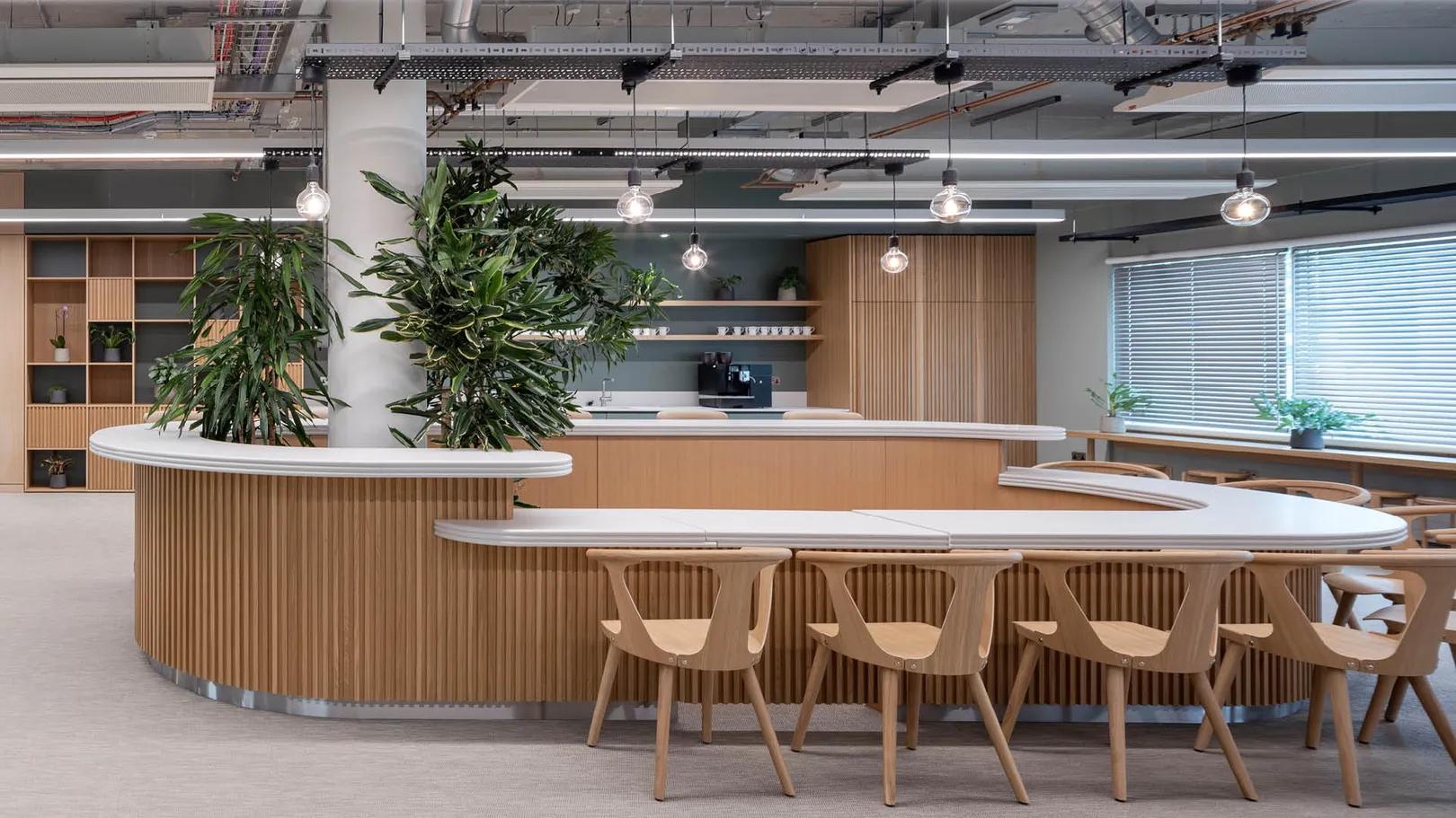 A circular wooden bar with seating and plants