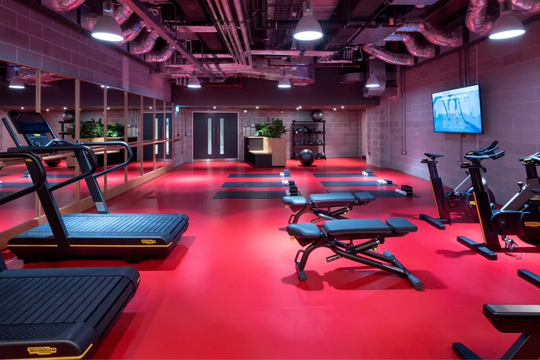 gym facilities in building with red floor and gym equipment