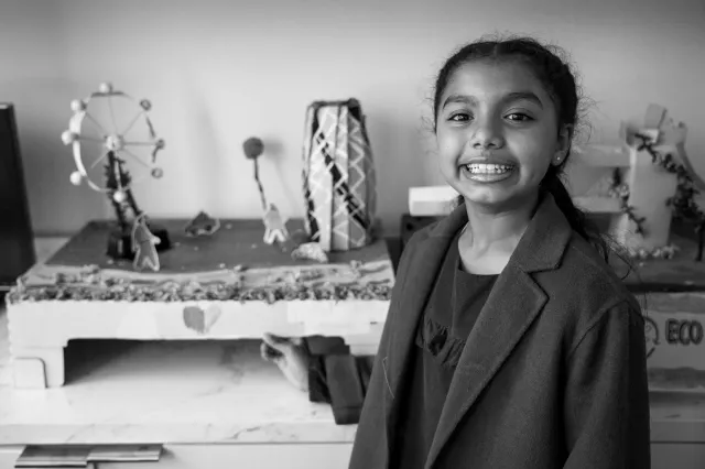 child nest to her artwork