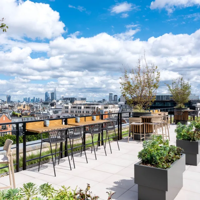 A roof terrace with planters and bar seating
