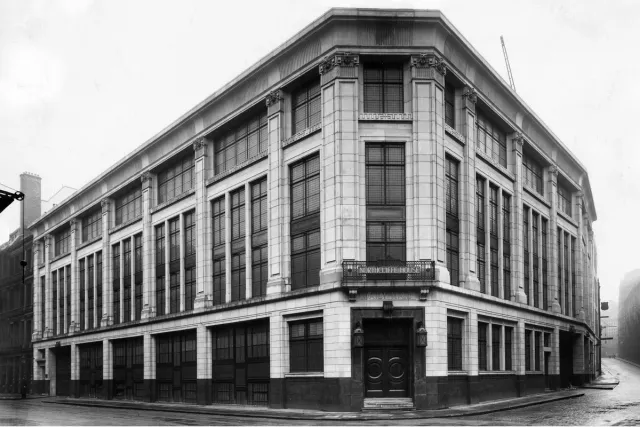 historical image of corner of building from street view black and white
