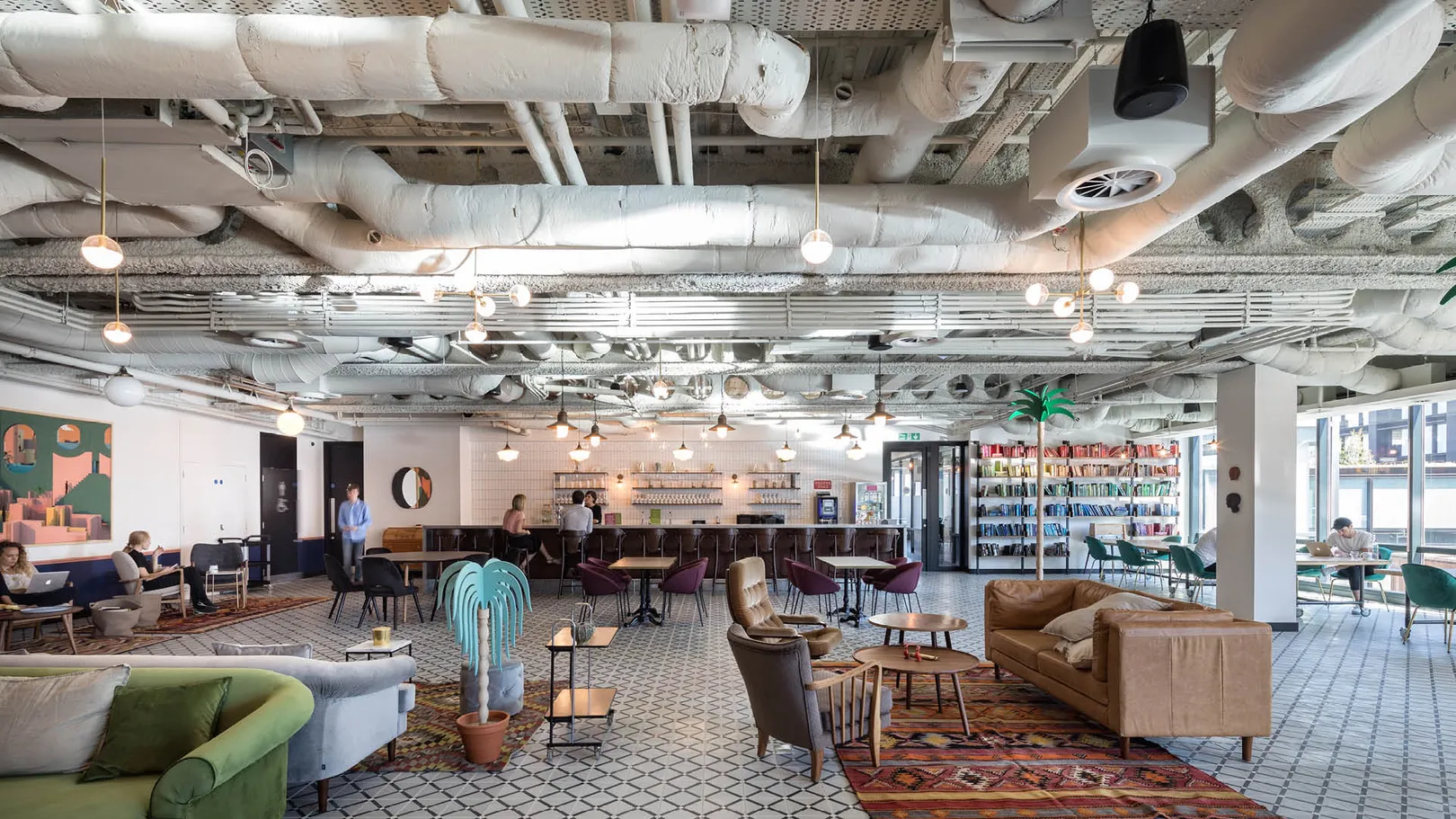 A large office floor with sofas and chairs in different lounge configurations
