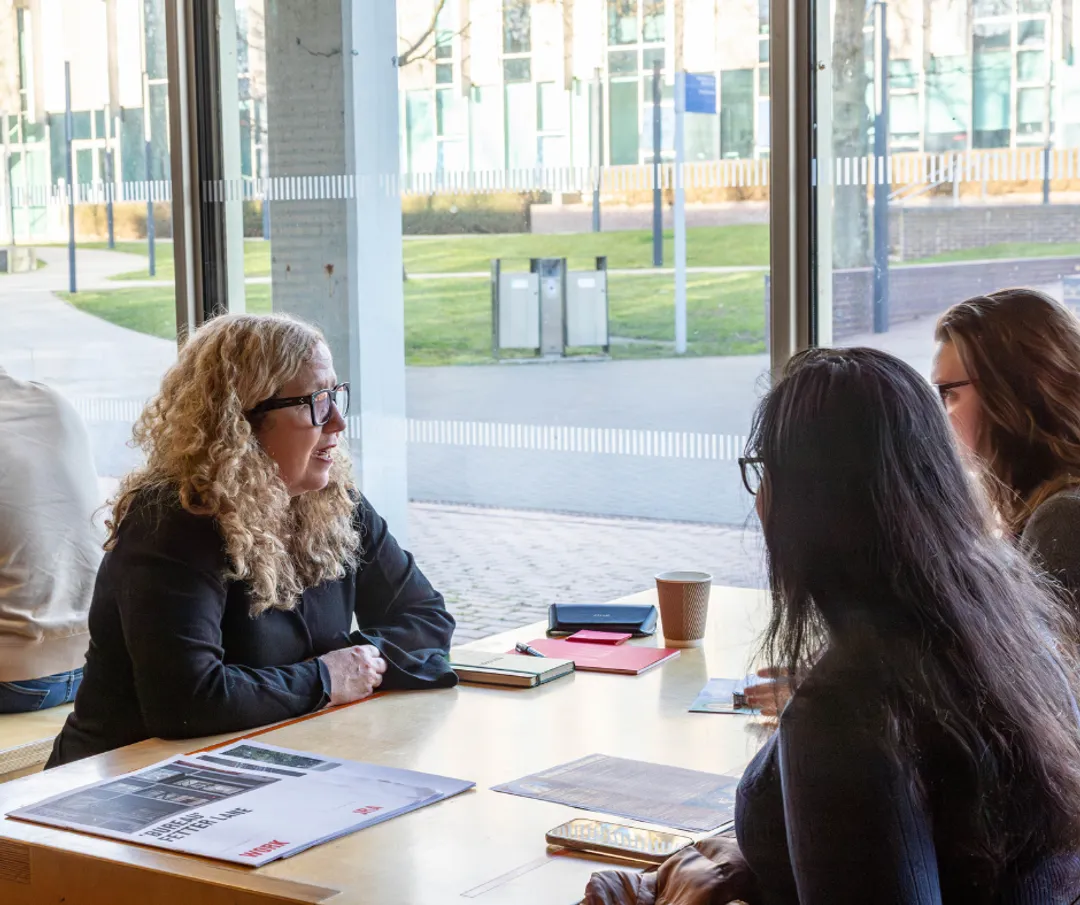 Etain giving portfolio review to two girls
