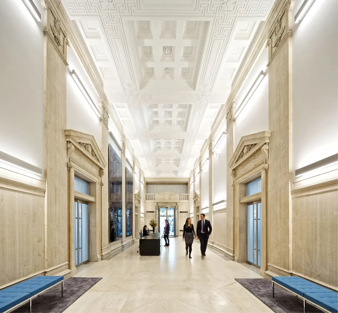 interior image of reception in modern building with people walking