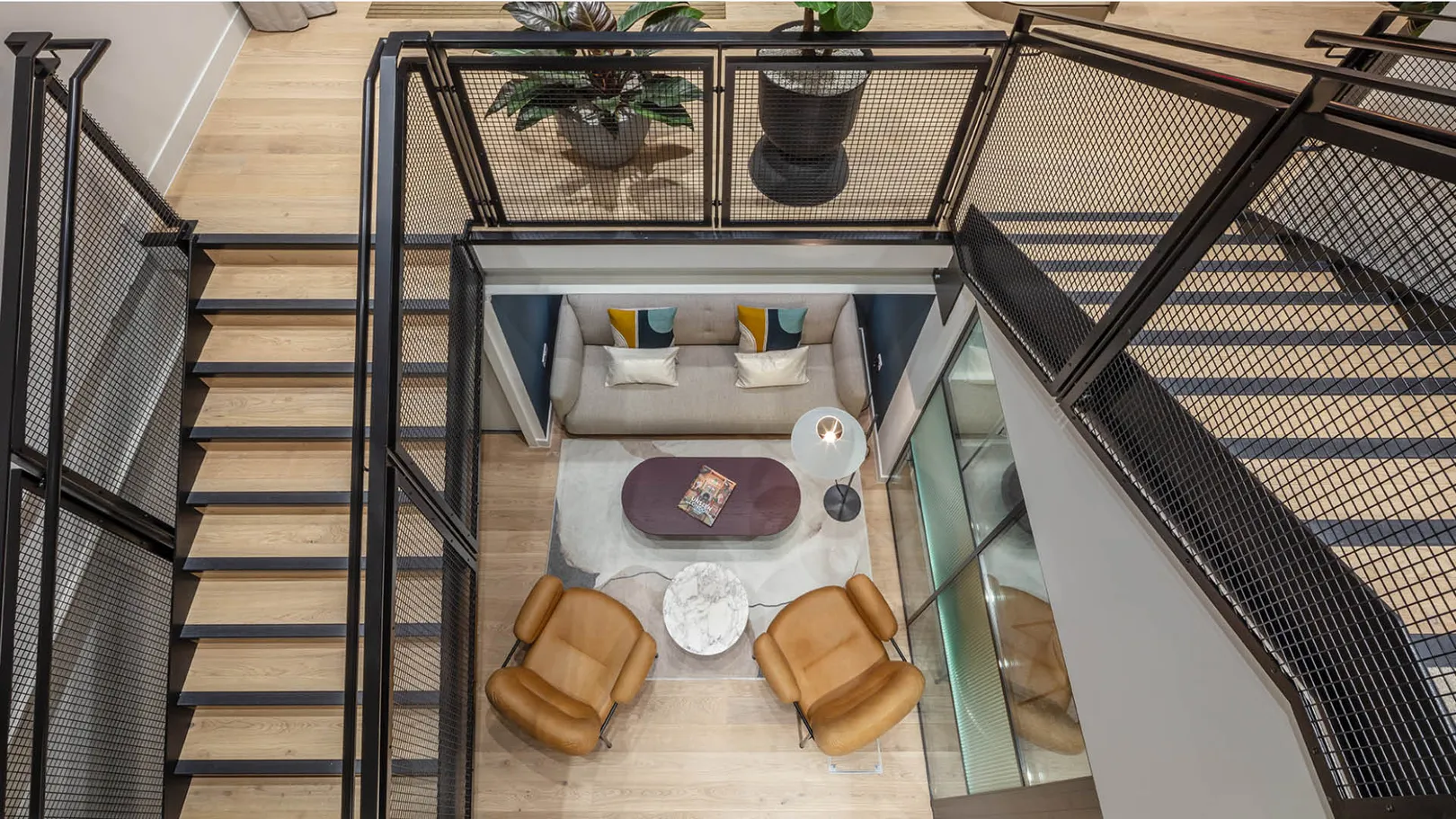 Aerial View of sofa and chairs from office wood and steel staircase