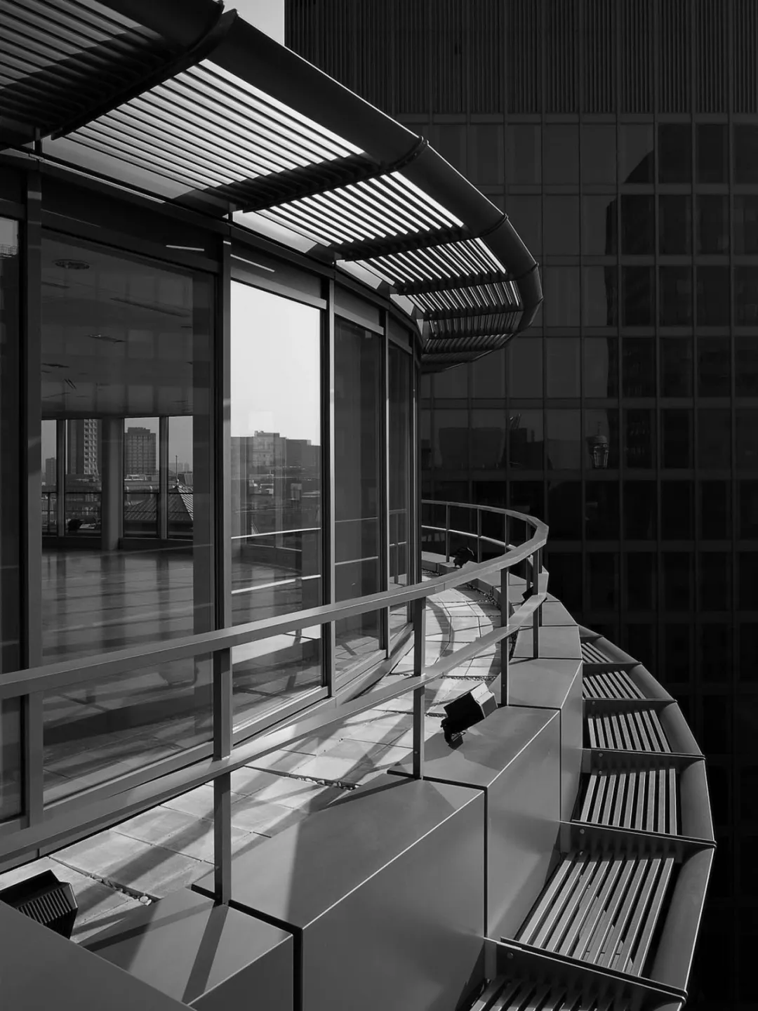 Black and white image of original office building detail showing full height windows and railings