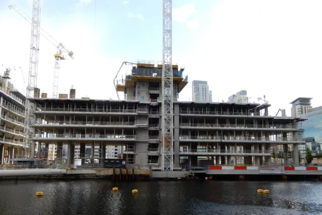 Front view of a building shell being constructed 