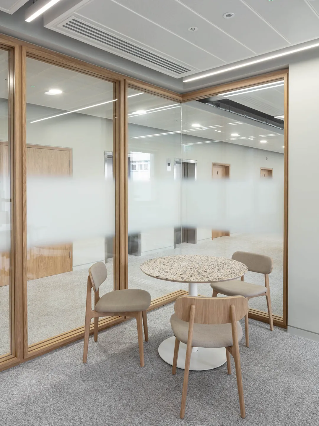 Desk and three chairs in an office
