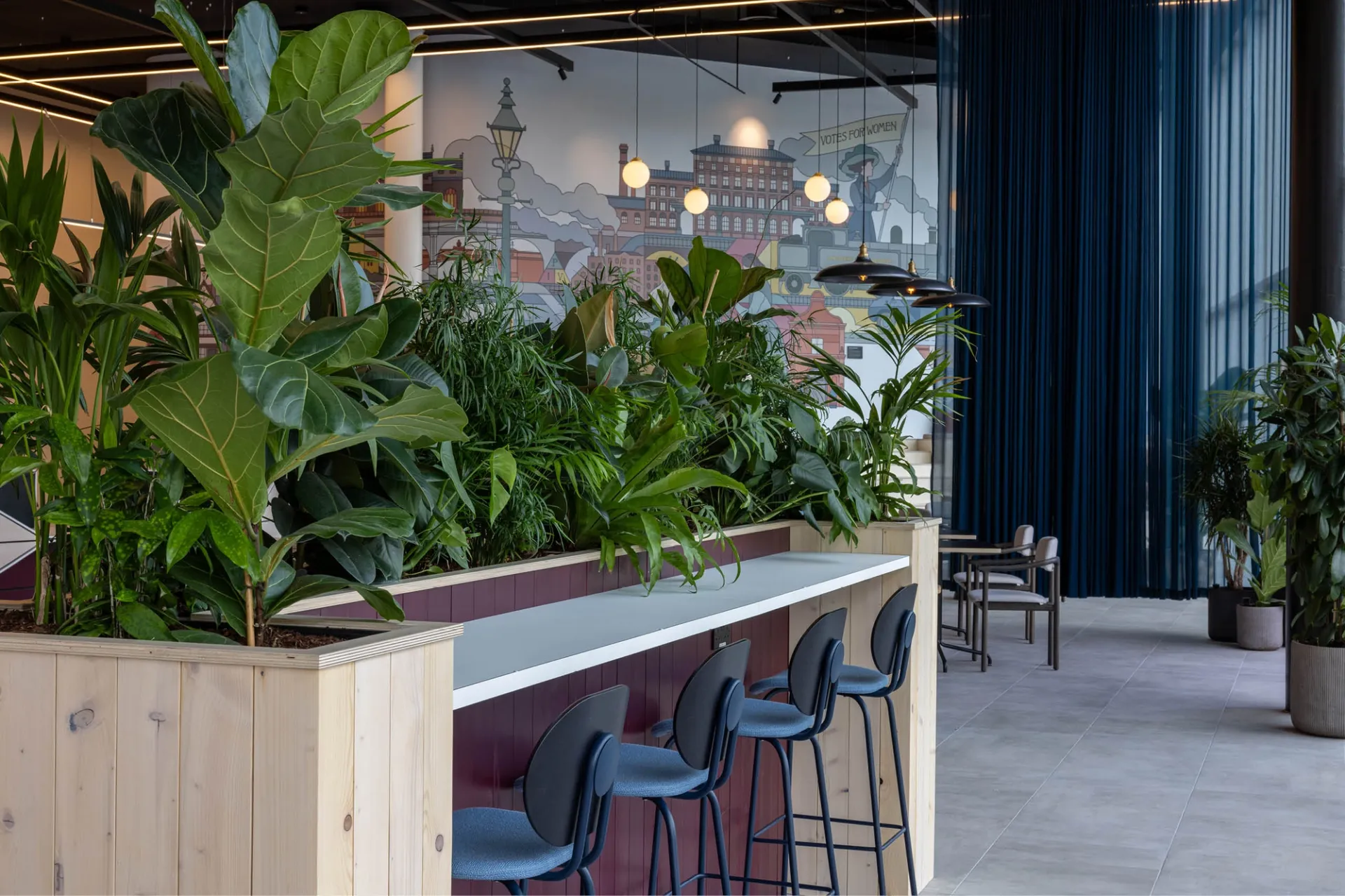 High stools at a bar surrounded by plants