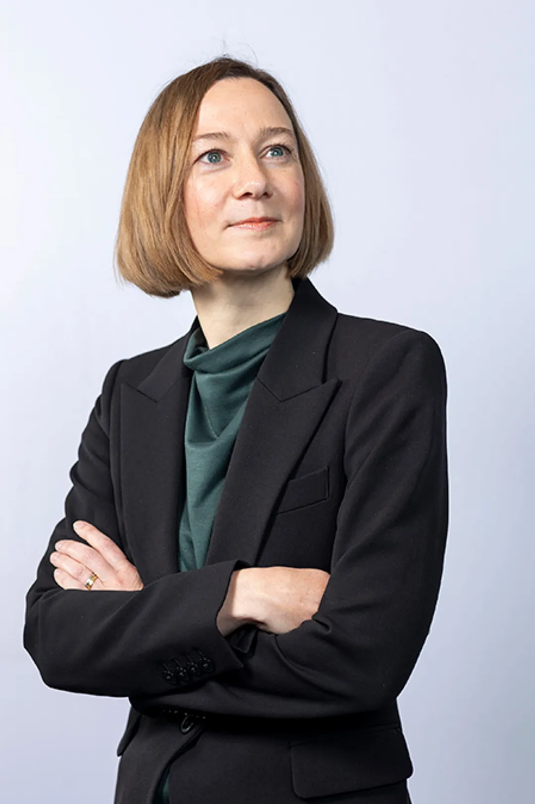 Portrait of person in black jacket with green top