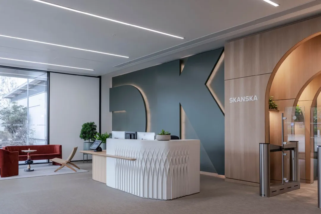 A reception desk with lobby seating and access gates on either side