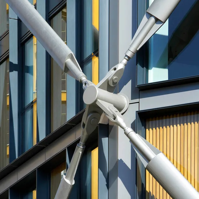 Close up of cross-bracing on corner of glass residential tower