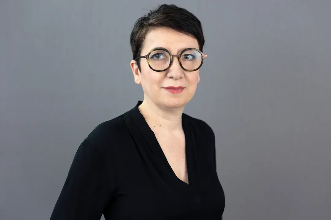 Portrait of woman in glasses and black clothes