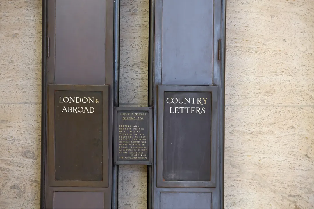detail of historical post boxes in building