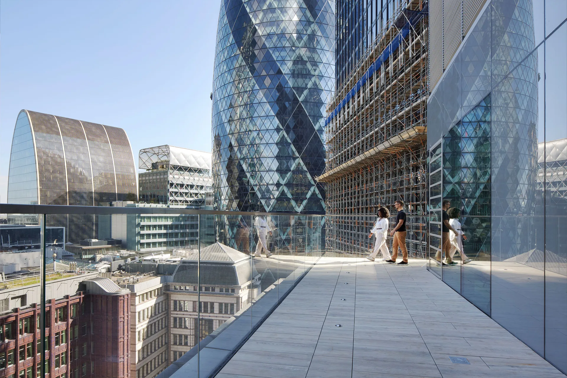 Two people on terrace overlooking City of London skyline