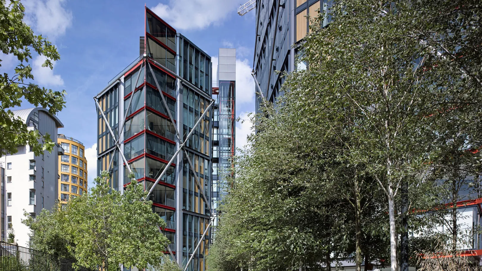 View of modern apartment block with diamond structural steel beams with red detail