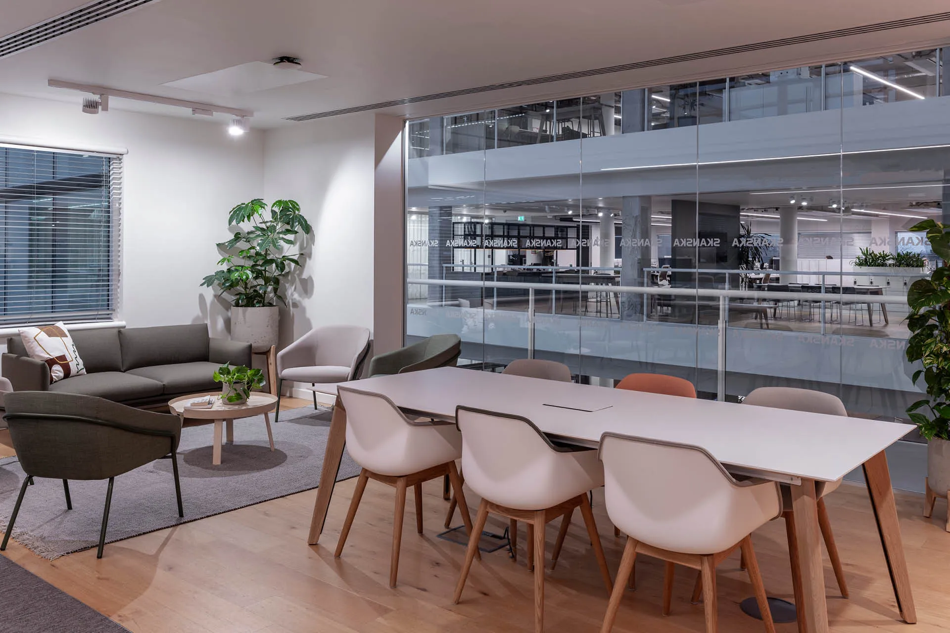A meeting desk with a sofa and chairs behind
