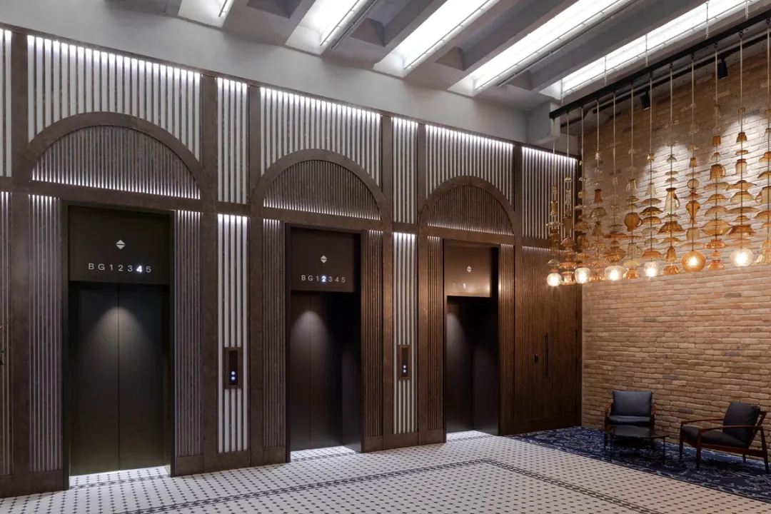 Reception lift lobby with exposed brick and seating