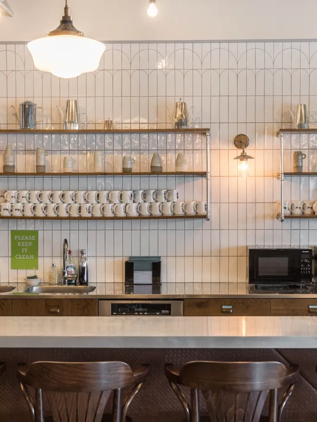 Shelves with cups and ornaments in an office kitchenette