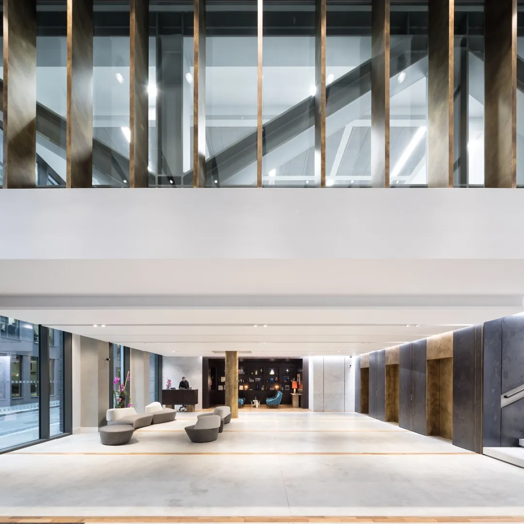 reception image with chairs, elevators and stairs white and grey colours