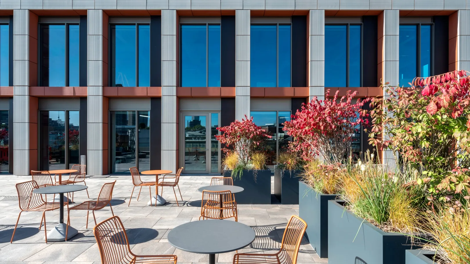 Roof Terrace view of the building with chairs and plants