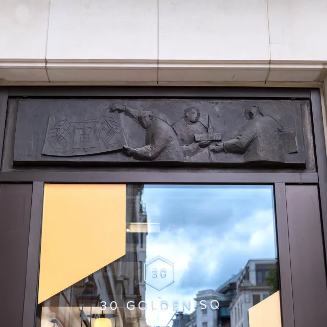 Close up of bronze casting above office exterior window