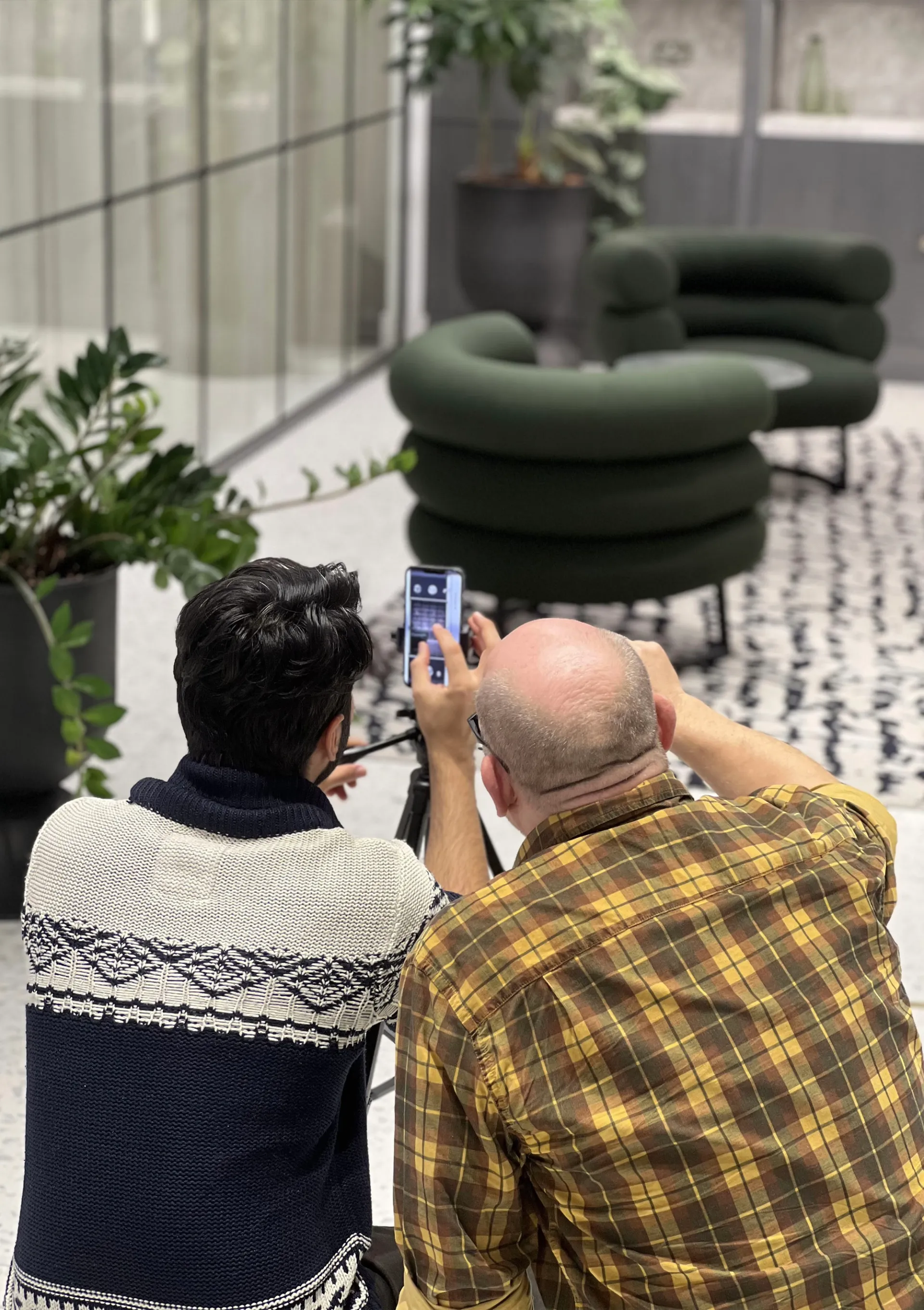 two people taking a photograph inside interior