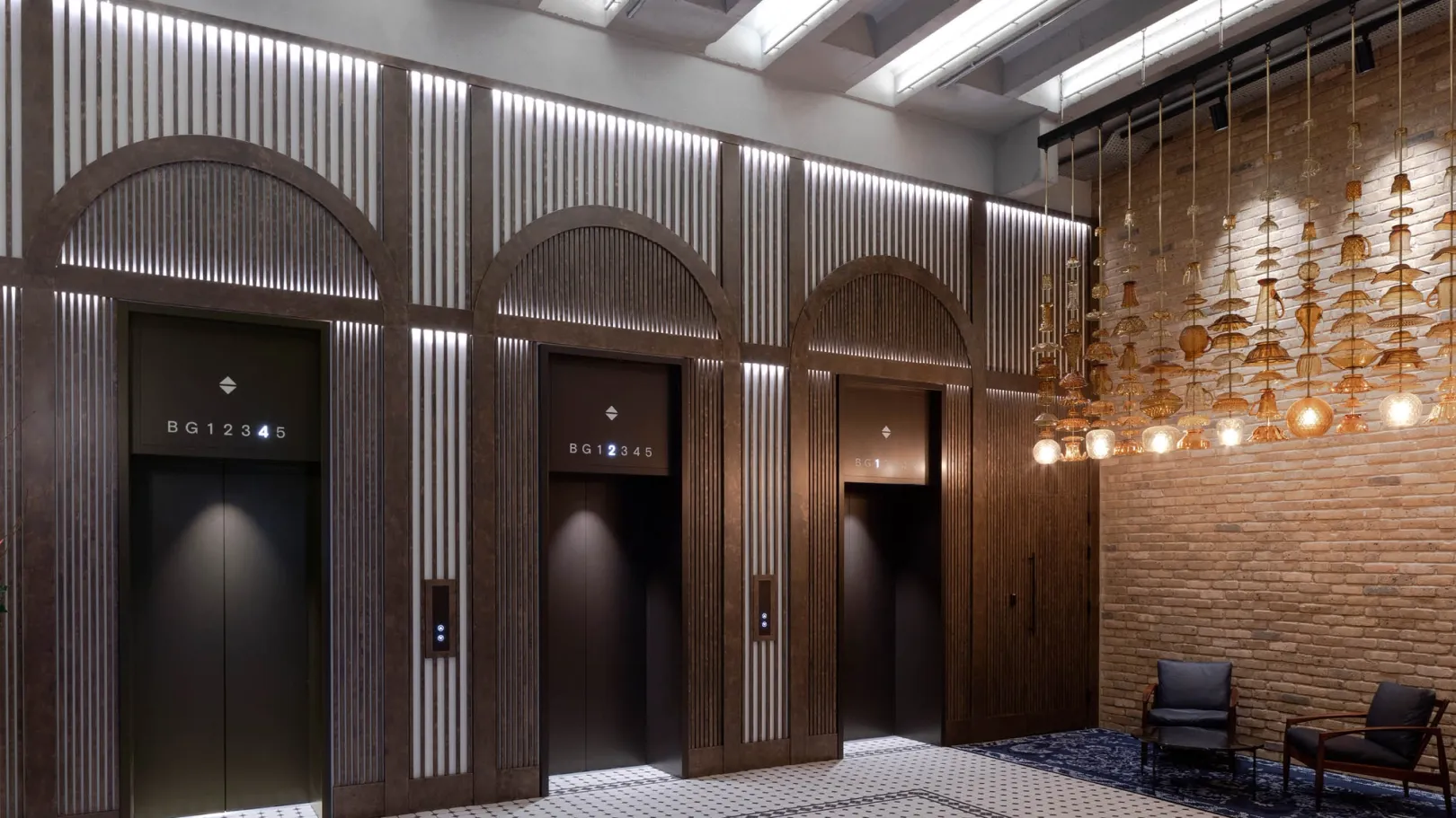 A brown furnished lift lobby with glass pendant lighting
