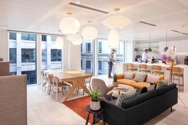 A meeting desk, lounge area and kitchenette in an office