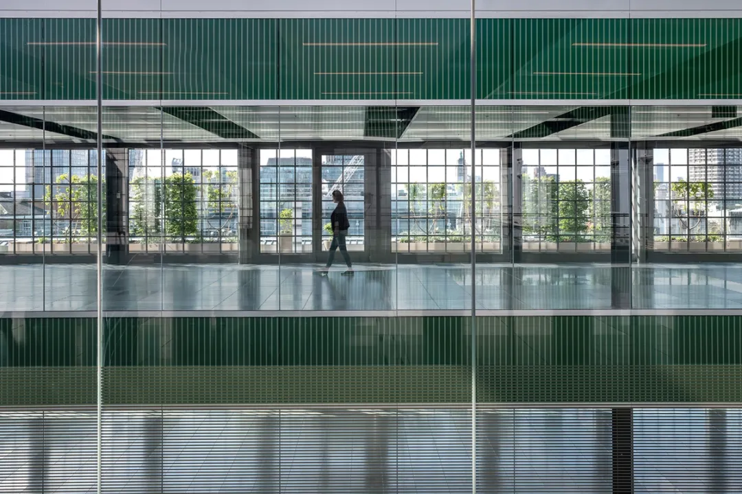 green atrium of building with person walking 