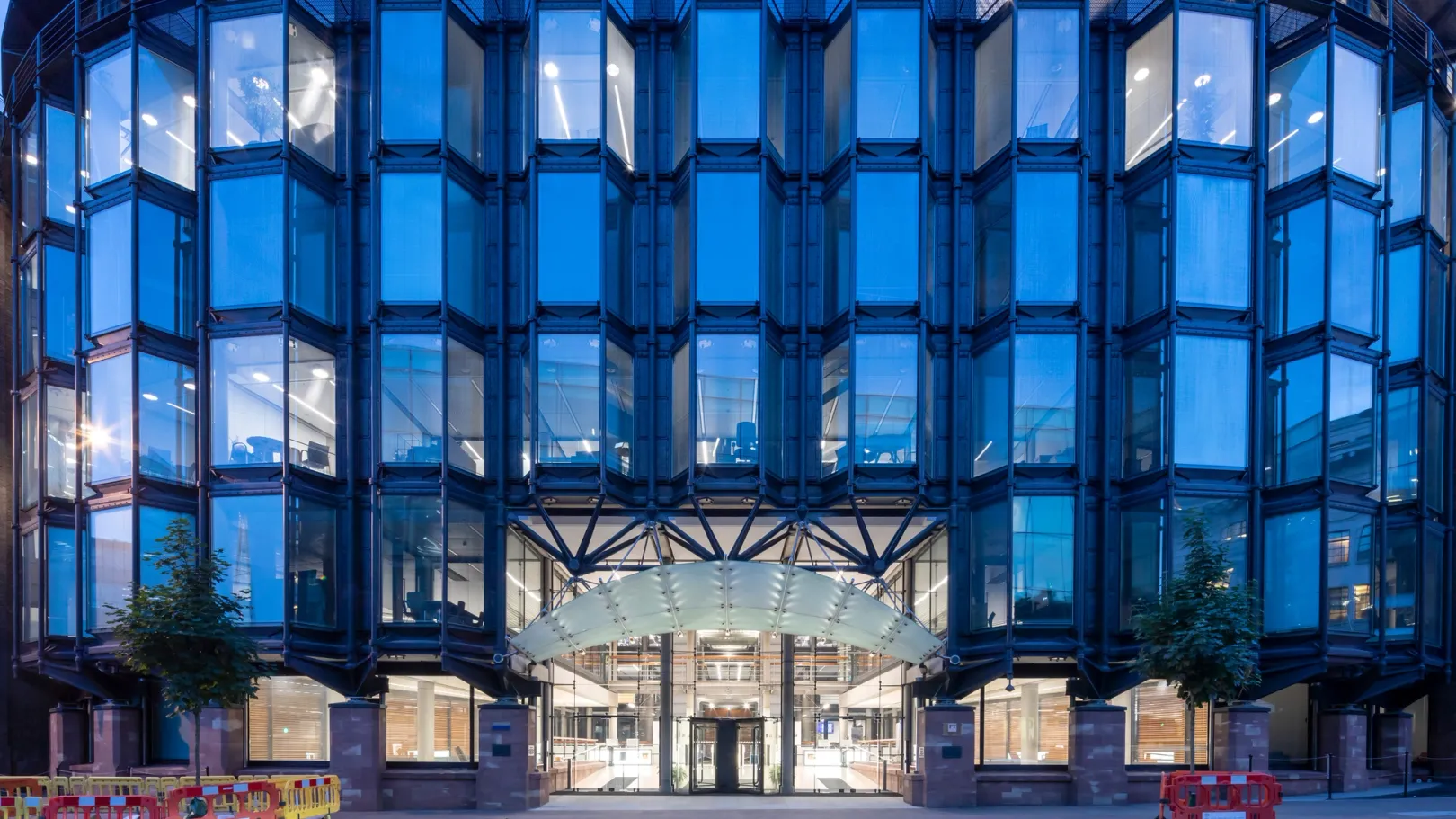 Glass building reflecting blue sky at dusk