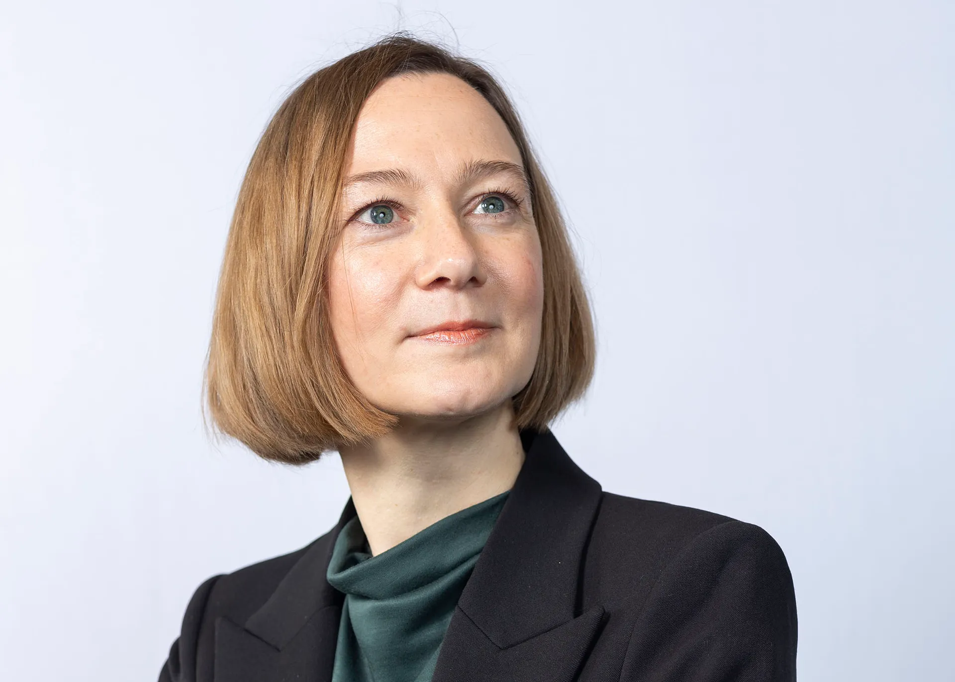 A photo of Anja, a white woman in black blazer