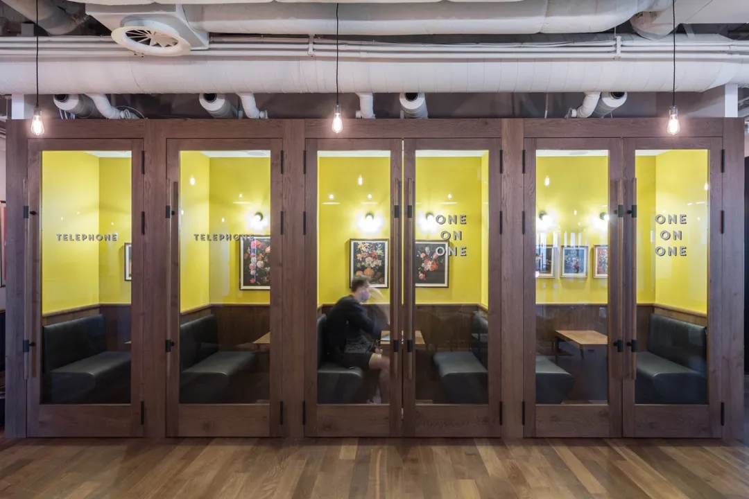 Enclosed sofa booths with yellow walls