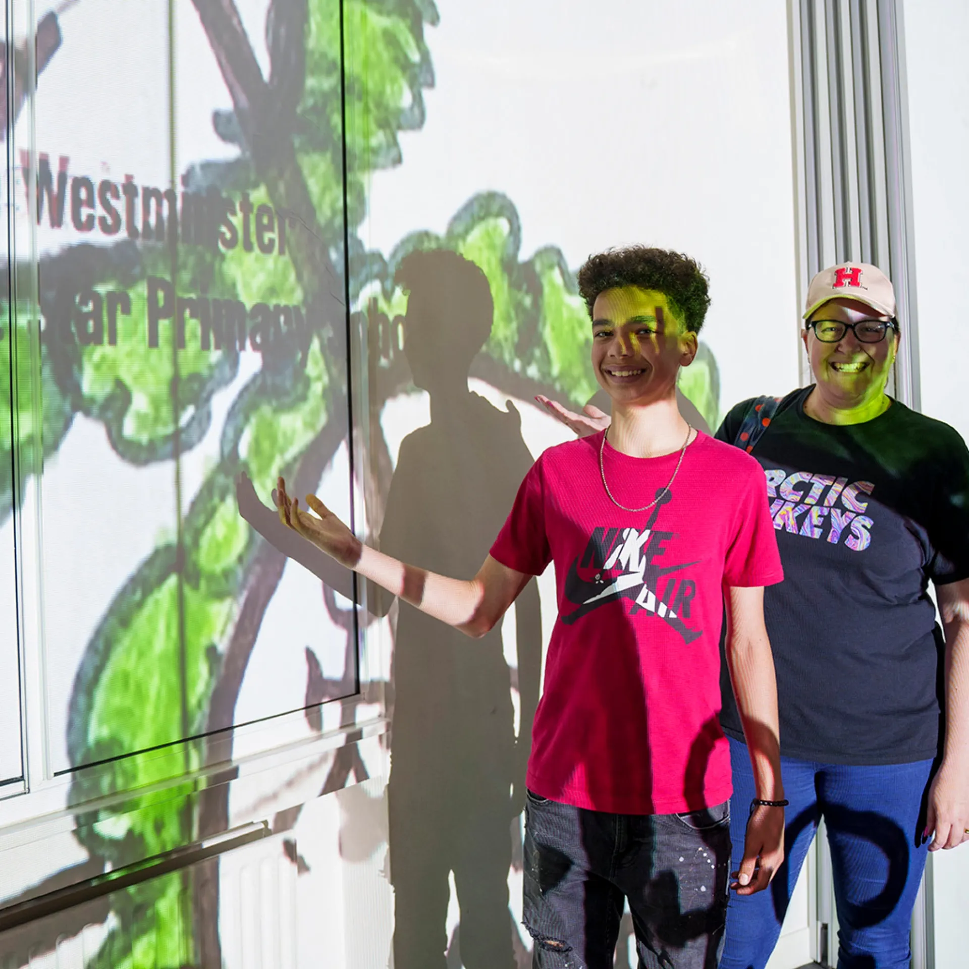 child and teacher in front of video installation