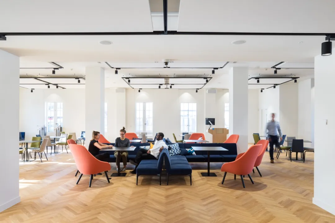 university lounge area with people sitting on chairs