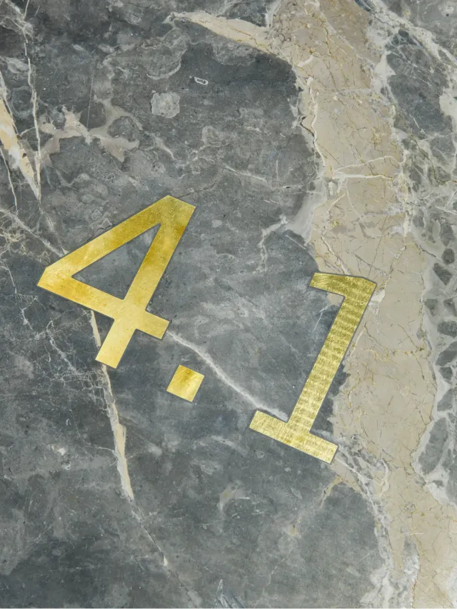 Brass numbers 4.1 inlaid in grey marble