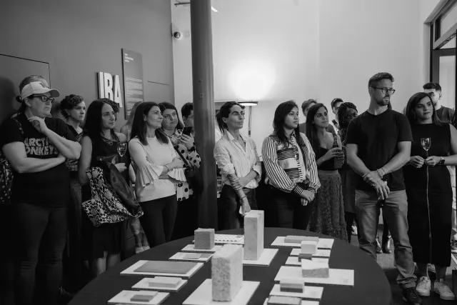 audience listening talk standing next to exhibition